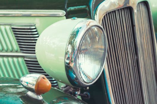 headlight and radiator of an old retro car closeup