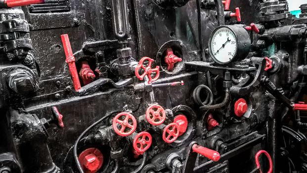 controls and valves in the cabin of an old steam locomotive