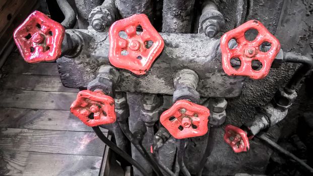 controls and valves in the cabin of an old steam locomotive