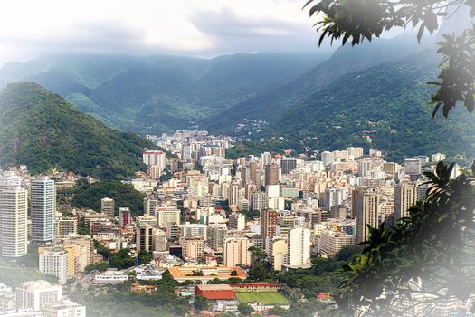 Top view of the city of Rio de Janeiro Brazil, surrounded by green mountains and shrouded in morning fog