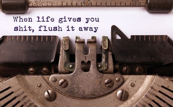 When life gives you shit, flush it away, written on an old typewriter, vintage