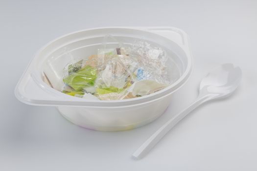 Conceptual visualization of the plastic soup problems by a plastic soup bowl filled with plastic and a plastic soup spoon
