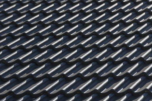 Roof hung with gray concrete roof tiles as background picture
