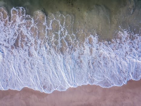 Drone picture of the waves hitting the beach on the Swahili Coast, Tanzania.