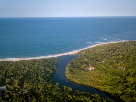 Drone picture of a lagoon in a coastal forest and the Indian ocean on the Swahili Coast, Tanzania.