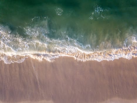 Drone picture of the waves hitting the beach on the Swahili Coast, Tanzania.