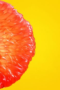 Peeled Slice Of Juicy Grapefruit on Yellow Background