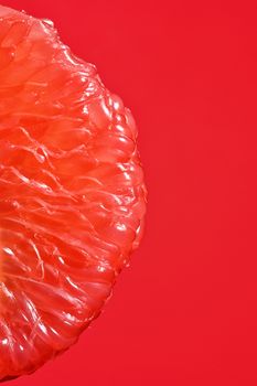 Peeled Slice Of Juicy Grapefruit on Red Background