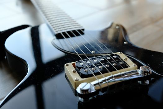 An electric guitar bridge closeup .