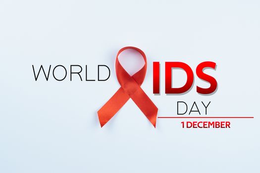 Aids awareness, red ribbon on white background with copy space for text. World Aids Day, Healthcare and medical concept.