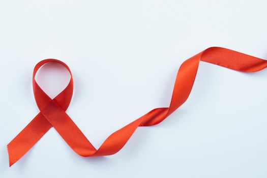 Aids awareness, red ribbon on white background with copy space for text. World Aids Day, Healthcare and medical concept.