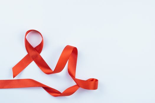 Aids awareness, red ribbon on white background with copy space for text. World Aids Day, Healthcare and medical concept.