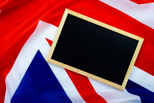 Flag of UK, British flag with blackboard, close up. Top view, copy space for text.