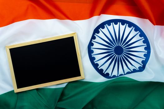 National flag of India with backboard on white background for Indian Independence day. Top view, copy space for text.