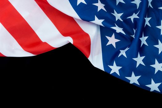 US American flag on black background. For USA Memorial day, Veterans day, Labor day, or 4th of July celebration. Top view, copy space for text.