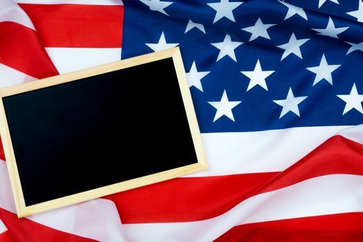 Blackboard on US American flag For USA Memorial day, Veterans day, Labor day, or 4th of July celebration. Top view, copy space for text.