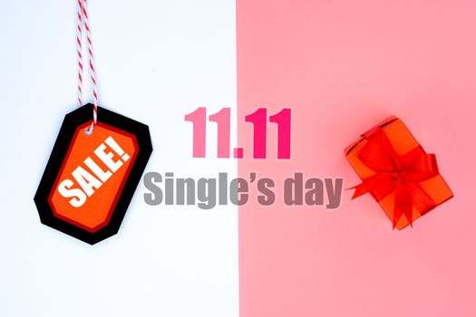 Online shopping of China, The shopping boxes with red rope and shopping tag on a white and pink background with copy space for text. 11.11 single's day sale concept