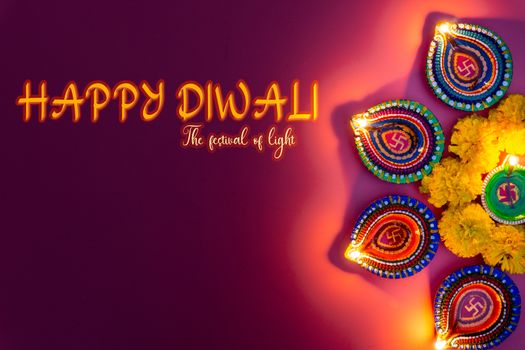 Indian festival Diwali, Diya oil lamps lit on colorful rangoli. Hindu traditional. Happy Deepavali. Copy space for text.