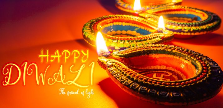 Indian festival Diwali, Diya oil lamps lit on colorful rangoli. Hindu traditional. Happy Deepavali. Copy space for text.