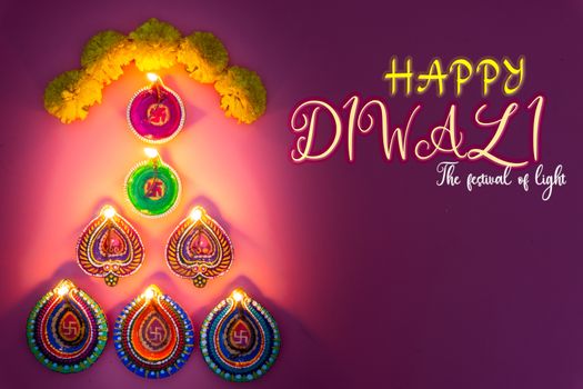 Indian festival Diwali, Diya oil lamps lit on colorful rangoli. Hindu traditional. Happy Deepavali. Copy space for text.