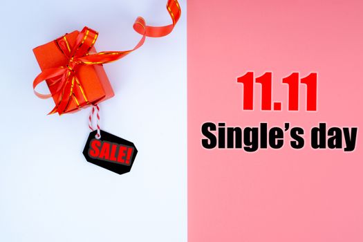 Online shopping of China, The Christmas boxes with red ribbon and shopping tag on a white and pink background with copy space for text. 11.11 single's day sale concept