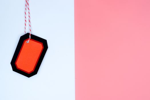 Online shopping of China, The red and black shopping tag with red rope on a white and pink background with copy space for text. 11.11 single's day sale concept
