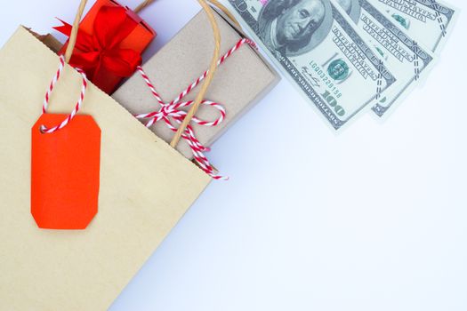 Online shopping of China, The shopping bag and Christmas boxes with red ribbon and banknote on a white background with copy space for text. 11.11 single's day sale concept