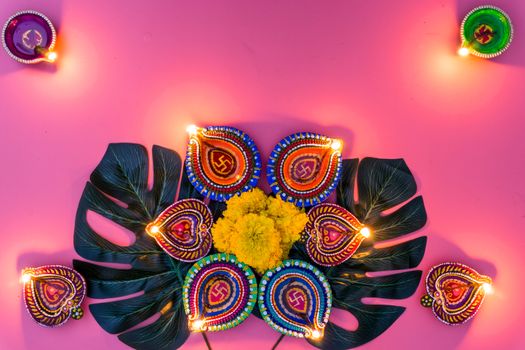 Indian festival Diwali, Diya oil lamps lit on colorful rangoli. Hindu traditional. Happy Deepavali. Copy space for text.