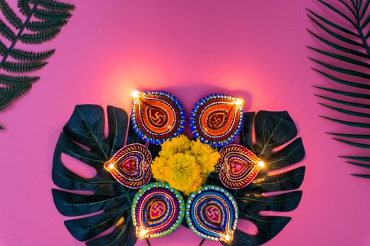 Indian festival Diwali, Diya oil lamps lit on colorful rangoli. Hindu traditional. Happy Deepavali. Copy space for text.