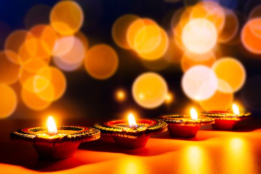 Indian festival Diwali, Diya oil lamps lit on colorful rangoli. Hindu traditional. Happy Deepavali. Copy space for text.