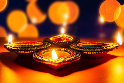 Indian festival Diwali, Diya oil lamps lit on colorful rangoli. Hindu traditional. Happy Deepavali. Copy space for text.