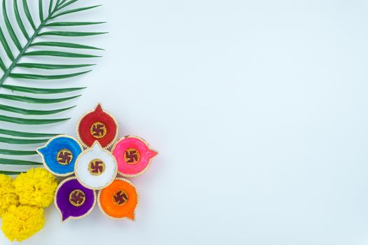 Indian festival Diwali, Diya oil lamps lit on colorful rangoli. Hindu traditional. Happy Deepavali. Copy space for text.