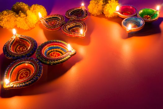 Indian festival Diwali, Diya oil lamps lit on colorful rangoli. Hindu traditional. Happy Deepavali. Copy space for text.