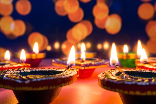 Indian festival Diwali, Diya oil lamps lit on colorful rangoli. Hindu traditional. Happy Deepavali. Copy space for text.