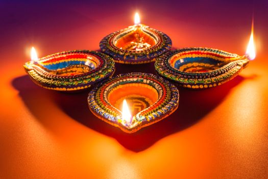 Indian festival Diwali, Diya oil lamps lit on colorful rangoli. Hindu traditional. Happy Deepavali. Copy space for text.