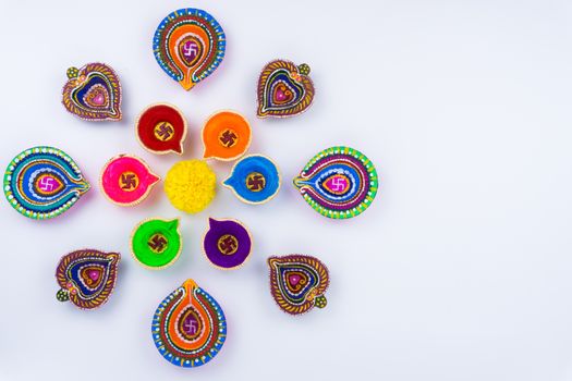 Indian festival Diwali, Diya oil lamps lit on colorful rangoli. Hindu traditional. Happy Deepavali. Copy space for text.