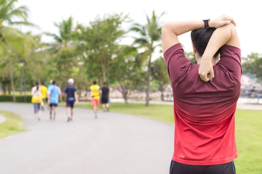 Young man stretching his arms before exercising and running. Sport and exercise concept.