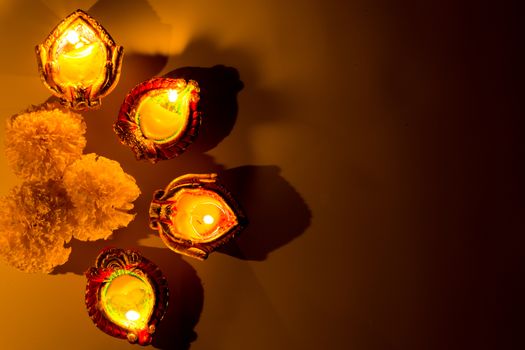 Indian festival Diwali, Diya oil lamps lit on colorful rangoli. Hindu traditional. Happy Deepavali.