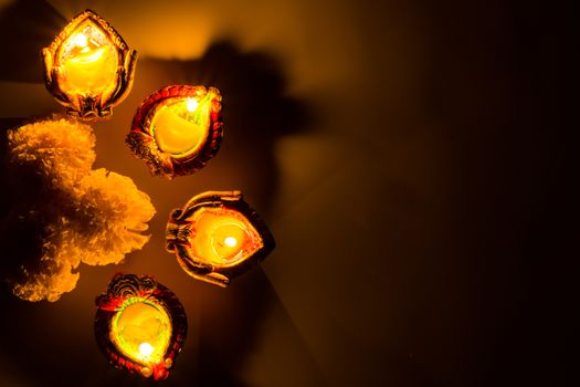 Indian festival Diwali, Diya oil lamps lit on colorful rangoli. Hindu traditional. Happy Deepavali.