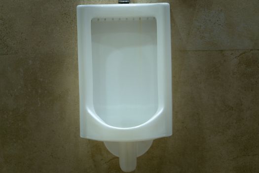 Men's room with white porcelain urinals in line. Comfort male toilet urinal concept.
