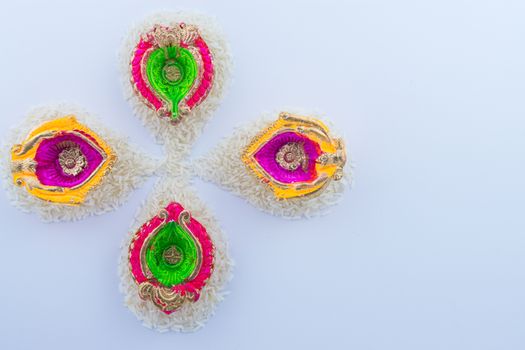 Indian festival Diwali, Diya oil lamps lit on colorful rangoli. Hindu traditional. Happy Deepavali.