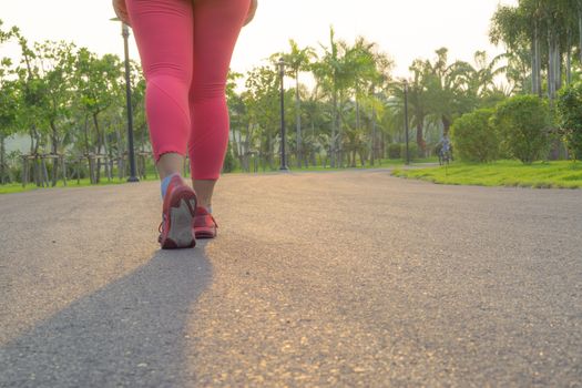 Closeup shoe. Female legs jogging and walking at the park. Sport and exercise concept