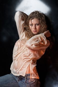 Young woman on a reflecting studio background