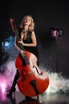 Young woman playing on a double bass