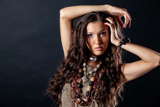 Young beautiful woman in ethnic clothing on a studio background