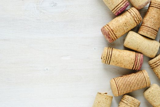 Set of used wine bottle corks, viewed in closeup with white table surface as copy space to the left