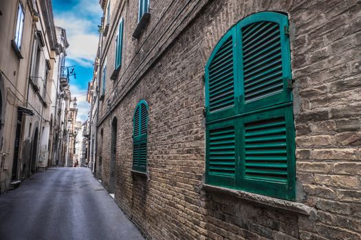 hdr deep narrow alley ground floor window house .