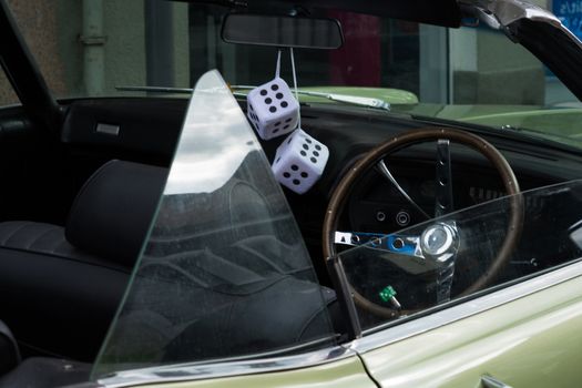 Fuzzy Dice on the rearview mirror of a vintage American car