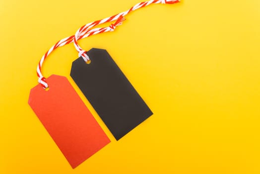 Red tag label and Black tag label on yellow background, blank copy space for you work