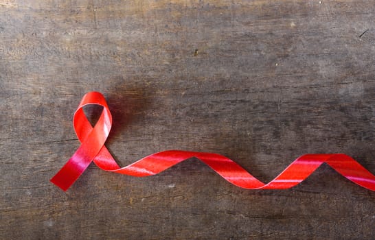 Red Ribbon Support HIV, AIDS on wooden background and copy space for use